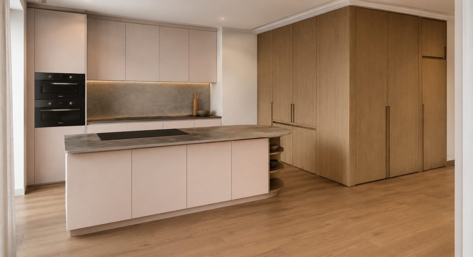The relocated kitchen, with warm timber joinery and a stone-topped island opening onto the garden