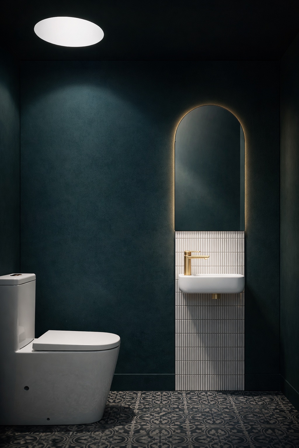 A luxurious, dramatic toilet room in deep green-blue with encaustic-look tiles